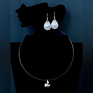 Earrings with anchors on them and  a necklace with a propeller charm set